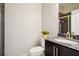 Well-lit bathroom with a granite countertop, dark wood cabinets, and a tiled shower in the background at 1199 Huff Nw Rd # 127, Atlanta, GA 30318
