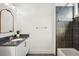 Modern bathroom featuring granite countertops, updated vanity, and shower with stylish gray tile at 1199 Huff Nw Rd # 127, Atlanta, GA 30318
