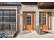 Charming front entrance with stone facade, bright orange doors, and well-manicured landscaping, providing curb appeal at 1199 Huff Nw Rd # 127, Atlanta, GA 30318