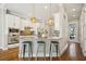 Stylish kitchen with white cabinetry, stainless steel appliances, pendant lighting, and breakfast bar seating three at 1199 Huff Nw Rd # 127, Atlanta, GA 30318