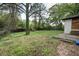 A large, tree-filled backyard featuring a patio and glimpses of the home's brick exterior at 1809 San Gabriel Ave, Decatur, GA 30032