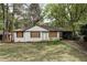 Quaint, single story home with white brick, dark trim and carport at 1809 San Gabriel Ave, Decatur, GA 30032
