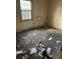 Bedroom with a window and visible trash on the ground and damaged walls at 2168 Clanton Ter, Decatur, GA 30034