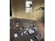 Unfurnished bedroom with window and visible trash on the ground at 2168 Clanton Ter, Decatur, GA 30034