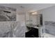 Upscale bathroom featuring marble tiling, an elegant vanity, a luxurious shower, and modern fixtures at 2767 Durham Ne Dr, Atlanta, GA 30319