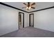 Carpeted bedroom with dark trim, ceiling fan, and access to other rooms at 2767 Durham Ne Dr, Atlanta, GA 30319