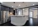 Bright kitchen with modern stainless steel appliances, a curved island counter, dark wood floors, and recessed lighting at 2767 Durham Ne Dr, Atlanta, GA 30319