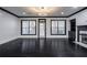 Bright living room featuring dark hardwood floors, fireplace, and black-trimmed windows providing ample natural light at 2767 Durham Ne Dr, Atlanta, GA 30319