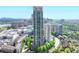 A stunning aerial view of a modern high rise, showcasing a vibrant city skyline and lush surrounding greenery at 750 Park Ne Ave # 13E, Atlanta, GA 30326