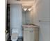 A stylish bathroom featuring a marble countertop and a well-lit vanity mirror at 750 Park Ne Ave # 13E, Atlanta, GA 30326