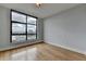 An empty bedroom with light walls, wooden floors, and a window showcasing an urban skyline at 750 Park Ne Ave # 13E, Atlanta, GA 30326
