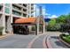 Grand building entrance with a covered driveway and well-maintained landscaping at 750 Park Ne Ave # 13E, Atlanta, GA 30326