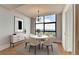 Bright dining room featuring a modern chandelier, round table, seating for six, and scenic views from a large window at 750 Park Ne Ave # 13E, Atlanta, GA 30326