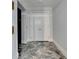 Hallway with marble floors leading to a unit door, next to the elevator at 750 Park Ne Ave # 13E, Atlanta, GA 30326