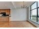 Kitchen area with chandelier, wood cabinets, black appliances, hardwood flooring and scenic outdoor view at 750 Park Ne Ave # 13E, Atlanta, GA 30326