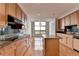 Modern kitchen with wood cabinets, granite countertops, stainless steel appliances, and hardwood flooring at 750 Park Ne Ave # 13E, Atlanta, GA 30326