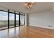 A spacious living room with floor-to-ceiling windows that open to a balcony and provides expansive views at 750 Park Ne Ave # 13E, Atlanta, GA 30326