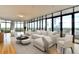 Bright living room featuring a large sectional sofa, modern seating, and floor-to-ceiling windows with city views at 750 Park Ne Ave # 13E, Atlanta, GA 30326