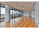 Bright living room featuring hardwood floors, floor-to-ceiling windows, and a stunning city view at 750 Park Ne Ave # 13E, Atlanta, GA 30326