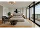 This main bedroom features an elegant design, a private balcony, and calming decor at 750 Park Ne Ave # 13E, Atlanta, GA 30326