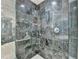 Walk-in shower featuring elegant marble tile and a dual shower head at 750 Park Ne Ave # 13E, Atlanta, GA 30326