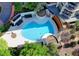 Aerial view of a luxury condo community pool surrounded by lush green trees at 750 Park Ne Ave # 13E, Atlanta, GA 30326