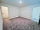 View of a bedroom with neutral walls and carpet, two doors visible at 7744 Sudbury Cir, Covington, GA 30014