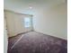 Clean bedroom with carpet, large window, and neutral paint at 7744 Sudbury Cir, Covington, GA 30014