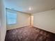 Well-lit bedroom featuring plush carpeting and a large window at 7744 Sudbury Cir, Covington, GA 30014