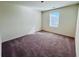 Cozy bedroom featuring carpet, natural lighting, and neutral-toned walls at 7744 Sudbury Cir, Covington, GA 30014