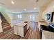 Well-lit kitchen boasts stainless steel appliances, center island, and modern finishes at 7744 Sudbury Cir, Covington, GA 30014