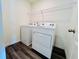 Bright laundry room with a washer, dryer, and wire shelf at 7744 Sudbury Cir, Covington, GA 30014