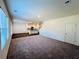 Bright and spacious living room with large windows, neutral carpeting, and access to kitchen at 7744 Sudbury Cir, Covington, GA 30014