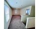 Spacious living room with plush carpeting, natural light and neutral paint colors at 7744 Sudbury Cir, Covington, GA 30014