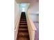 Carpeted staircase with white banisters leading to the upper level of the home at 7744 Sudbury Cir, Covington, GA 30014