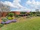Well-maintained backyard with mature landscaping and a brick wall at 1042 Pecan Grove Pl, Lawrenceville, GA 30046