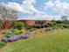 Well-maintained backyard with mature landscaping and a brick wall at 1042 Pecan Grove Pl, Lawrenceville, GA 30046