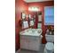 Classic bathroom with a single sink vanity, decorative wallpaper, and framed art at 1042 Pecan Grove Pl, Lawrenceville, GA 30046