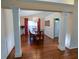 Open-concept dining room with pillars, chandelier, wood floors, and ample seating at 1042 Pecan Grove Pl, Lawrenceville, GA 30046