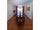 Dining room with a chandelier, wood floors, large table, and ample seating at 1042 Pecan Grove Pl, Lawrenceville, GA 30046