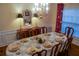 Elegant dining room with a formal table setting, chandelier, and window view at 1042 Pecan Grove Pl, Lawrenceville, GA 30046