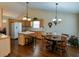 Open kitchen and dining area with hardwood floors and ample natural light at 1042 Pecan Grove Pl, Lawrenceville, GA 30046