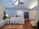 Bright living room featuring hardwood floors, neutral decor, and a ceiling fan at 1042 Pecan Grove Pl, Lawrenceville, GA 30046