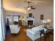 Elegant living room with a fireplace, plush seating, and beautiful hardwood floors at 1042 Pecan Grove Pl, Lawrenceville, GA 30046