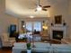 Bright living room with fireplace, hardwood floors, and neutral-toned furnishings at 1042 Pecan Grove Pl, Lawrenceville, GA 30046