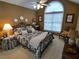 Comfortable main bedroom with a large window, decorative details, and a cozy ambiance at 1042 Pecan Grove Pl, Lawrenceville, GA 30046