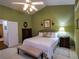 Spacious main bedroom with a ceiling fan, bench, and carpet at 1042 Pecan Grove Pl, Lawrenceville, GA 30046