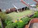 An aerial shot of a home's backyard showcasing a covered patio and lovely manicured landscaping at 1042 Pecan Grove Pl, Lawrenceville, GA 30046