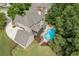 Stunning aerial view of brick home with an in-ground pool, outdoor seating area, and lush landscaping at 2788 Bridle Ridge Way, Buford, GA 30519