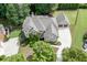 Aerial view of the beautiful brick home with a three-car garage, well-manicured lawn and landscaped grounds at 2788 Bridle Ridge Way, Buford, GA 30519